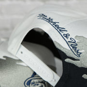 mitchell and ness logo on the Georgetown University Hoyas Vintage Retro Paintbrush Mitchell and Ness Snapback Hat | White/Navy Blue/ Gray