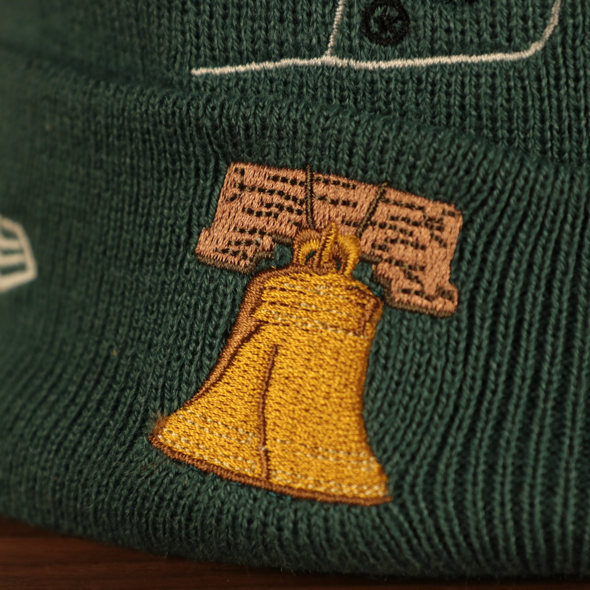 liberty bell logo on the Philadelphia Eagles "City Transit" 59Fifty Fitted Matching All Over Side Patch Beanie