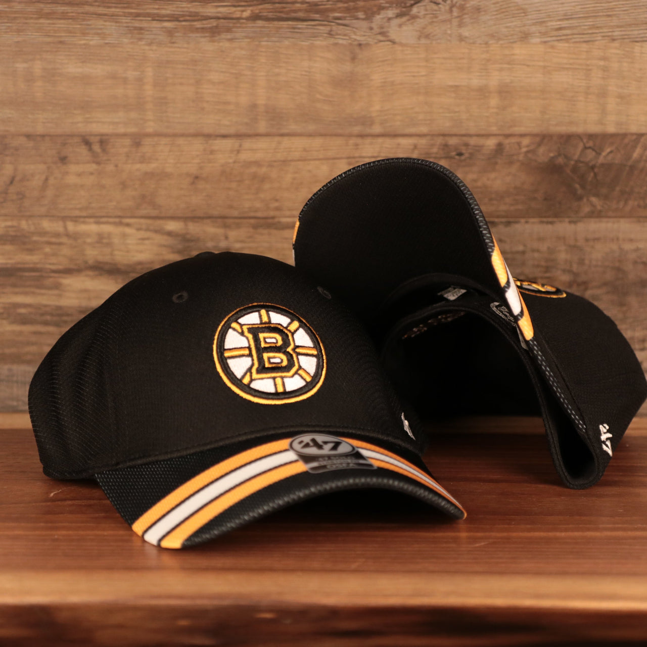 front and bottom of the Boston Bruins Black & Yellow Stretch Fit Dad Hat