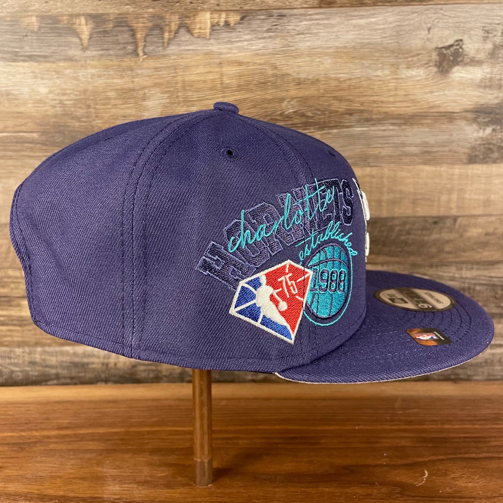 Wearer's right of the Charlotte Hornets NBA 75th Anniversary Side Patch Gray Bottom Purple 9Fifty Snapback Hat | Back Half