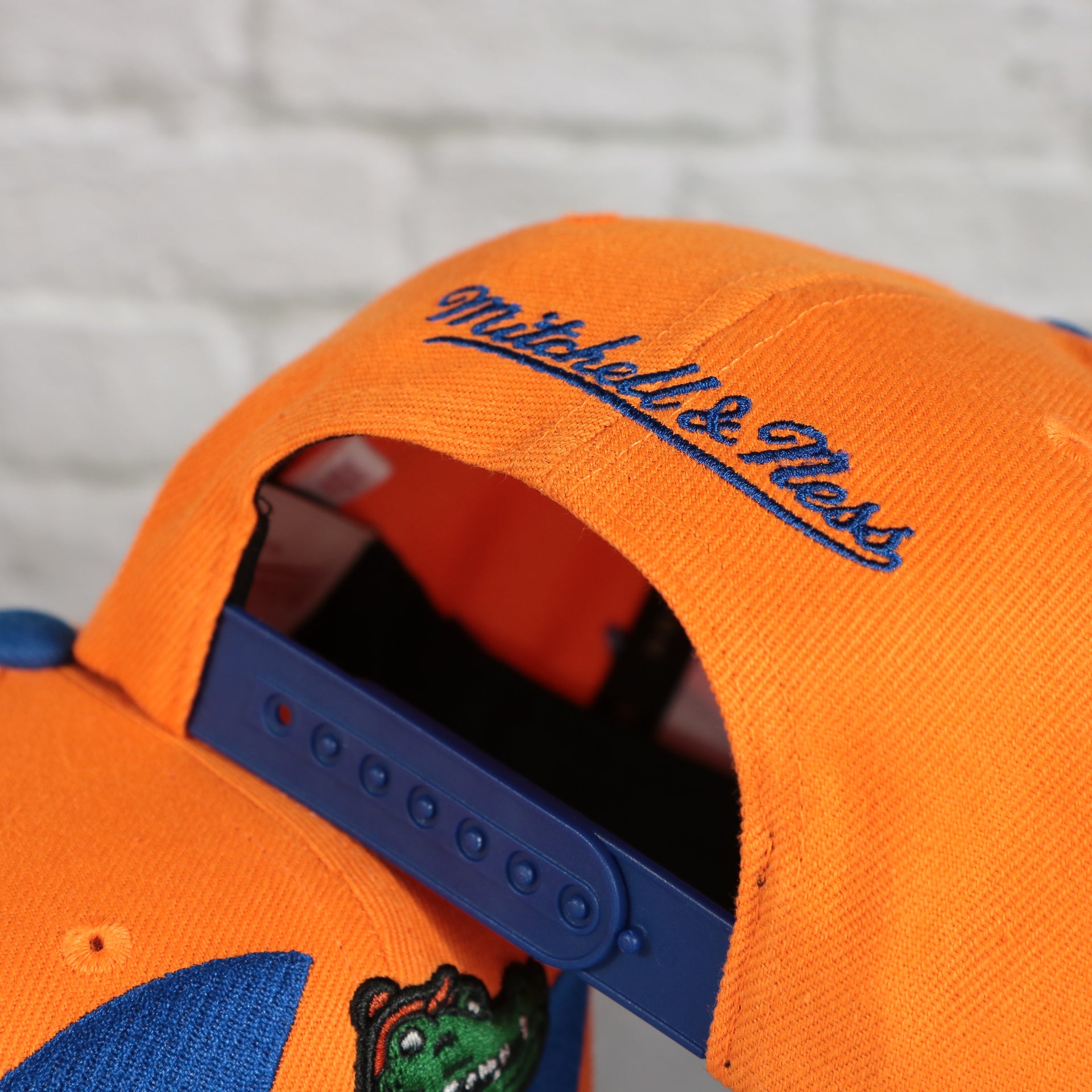 mitchell and ness logo on the University of Florida Gators Vintage Retro Sharktooth Mitchell and Ness Snapback Hat | Orange/Blue