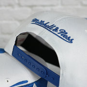 mitchell and ness logo on the Duke University Blue Devils Vintage Retro Sharktooth Mitchell and Ness Snapback Hat | Blue/White