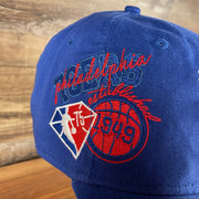 Close up of the side patch on the Philadelphia 76ers NBA 75th Anniversary Side Patch Royal 9Twenty Dad Hat | Back Half