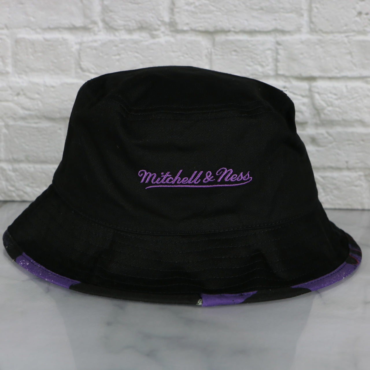 mitchell and ness logo on the Toronto Raptors 90s Inspired NBA Hyper Mitchell and Ness Reversible Bucket Hat
