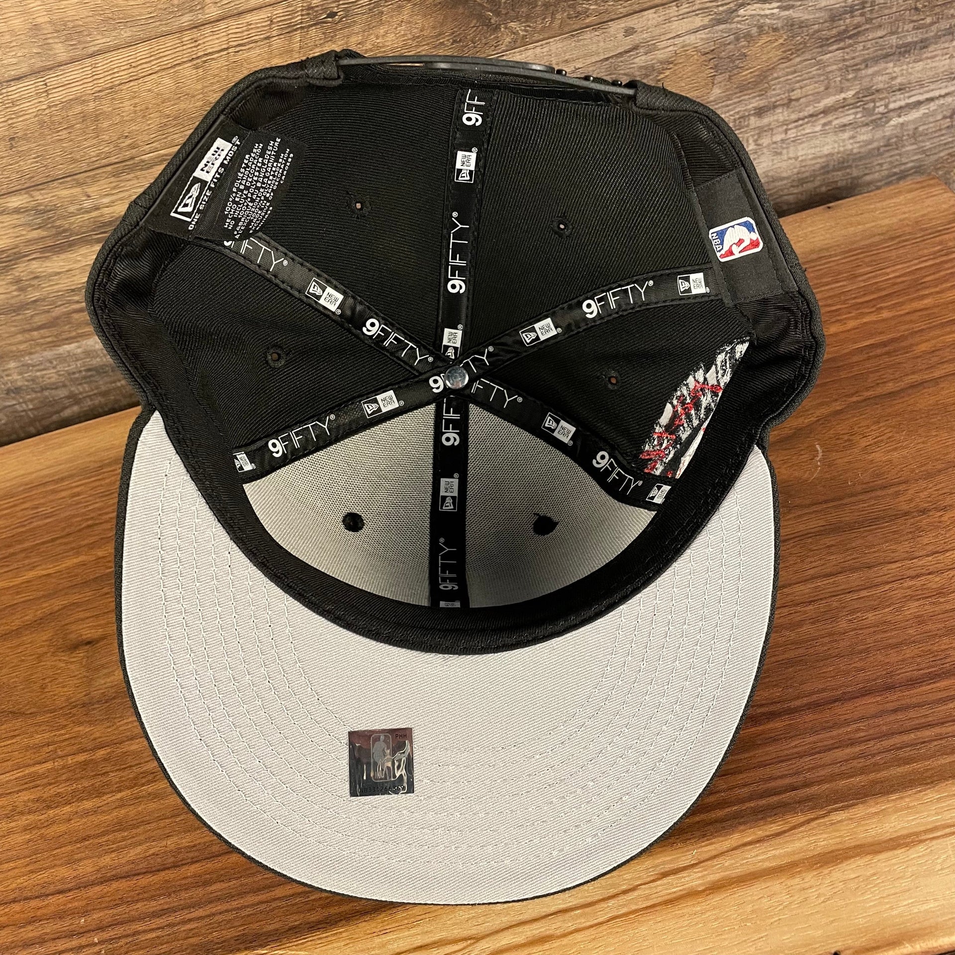 Grey under visor of the Portland Trail Blazers NBA 75th Anniversary Side Patch Gray Bottom Black 9Fifty Snapback Hat | Back Half