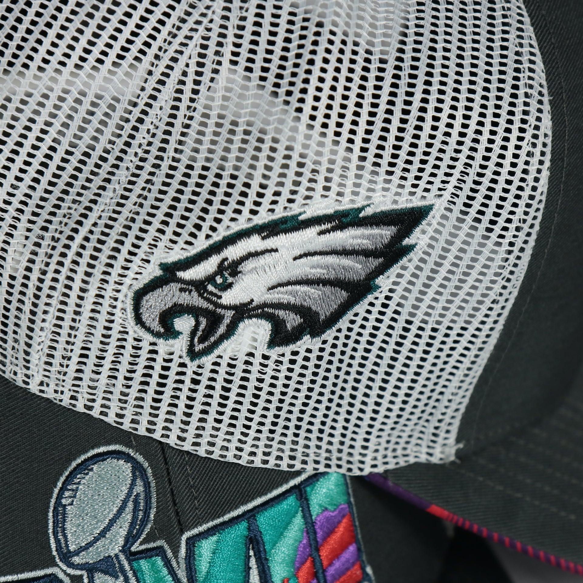 Wearer's right of the Philadelphia Eagles Super Bowl LVII (Super Bowl 57) Side Patch Charcoal/White Trucker Hat featuring the Philadelphia Eagles logo