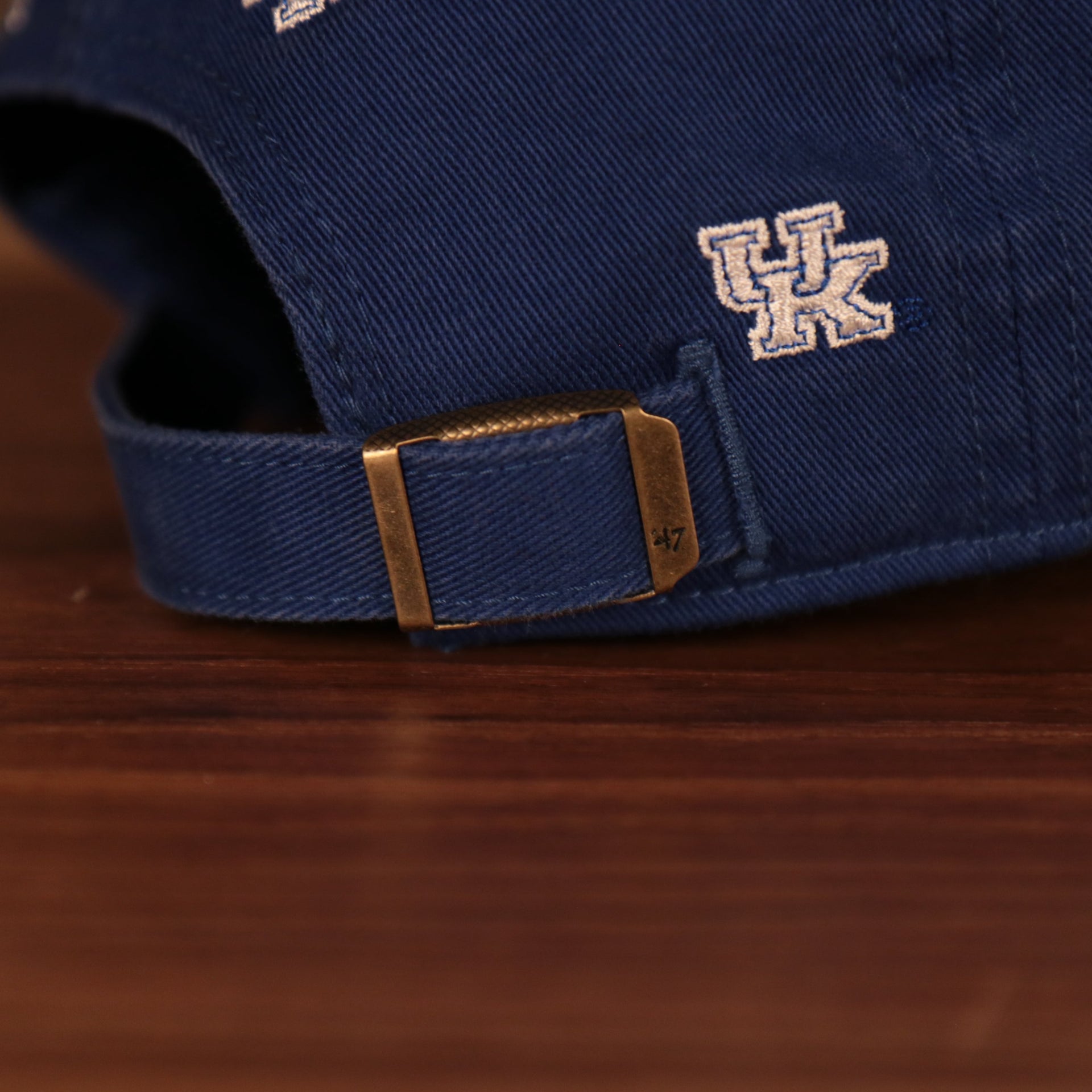adjustable strap on the back of the University of Kentucky Wildcats All Over Logo Patch Blue Adjustable Dad Hat