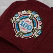 100th anniversary side patch on the Philadelphia Phillies Cooperstown 100th Anniversary Side Patch Green Bottom 59Fifty Maroon Fitted Cap | Botanical Pack