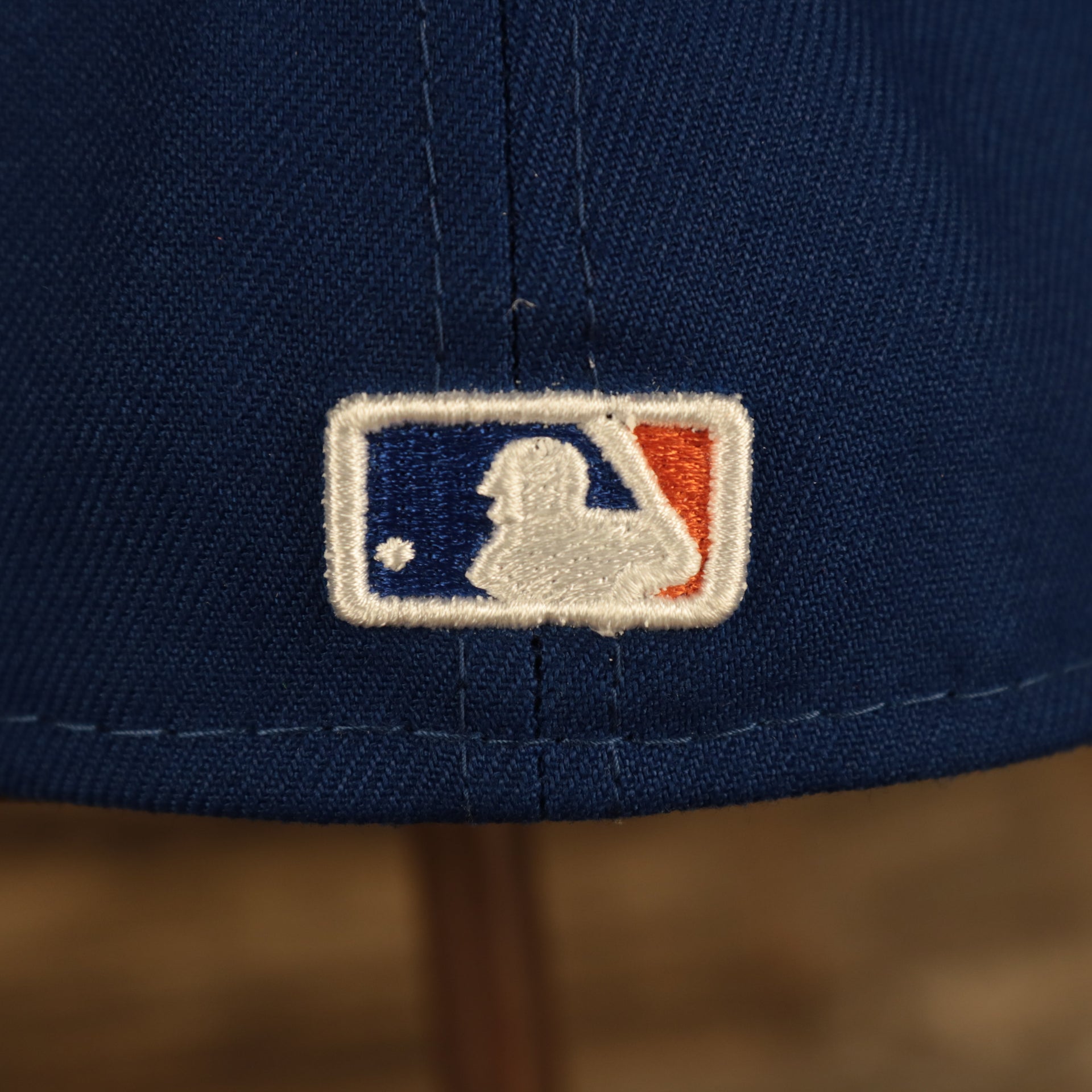 Close up of the MLB Batterman logo on the back of the New York Mets "City Cluster" Side Patch Gray Bottom Royal 59Fifty Fitted Cap