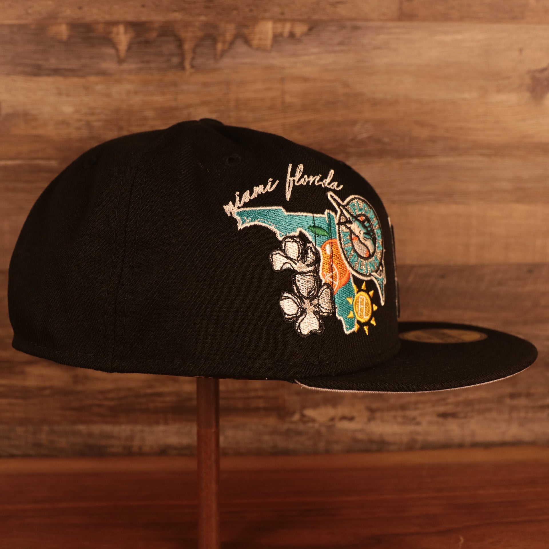 Wearer's right of the Florida Marlins Cooperstown "City Cluster" Side Patch Gray Bottom Black 59Fifty Fitted Cap
