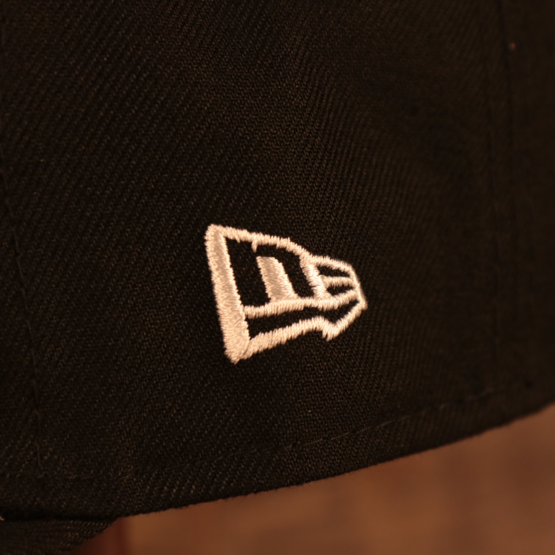 Close up of the New Era logo on the Florida Marlins Cooperstown "City Cluster" Side Patch Gray Bottom Black 59Fifty Fitted Cap