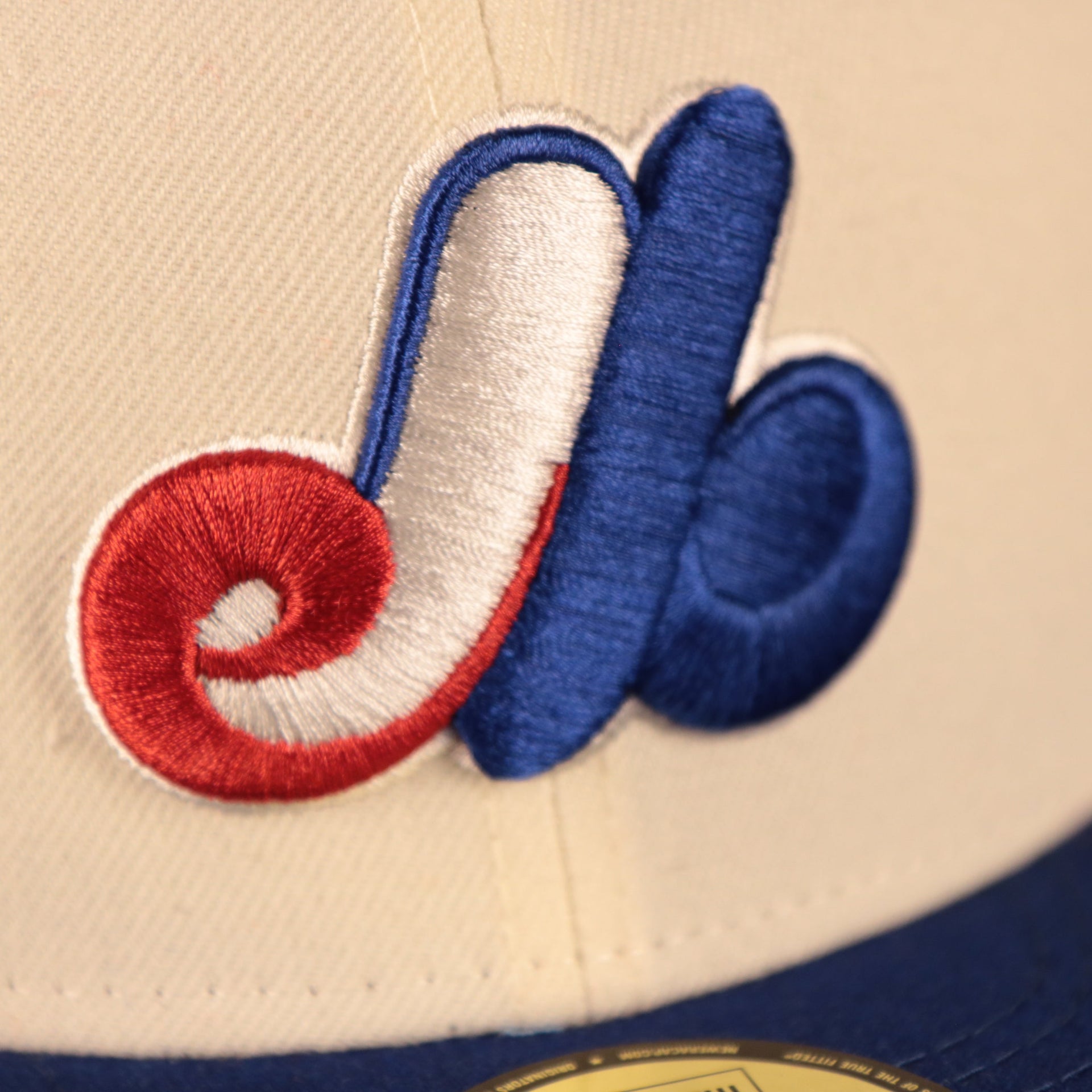 Close up of the Montreal Expos logo on the Montreal Expos 1982 All Star Game Partie D'etoiles Crystal Side Patch Icy Blue Bottom 59Fifty Fitted Cap