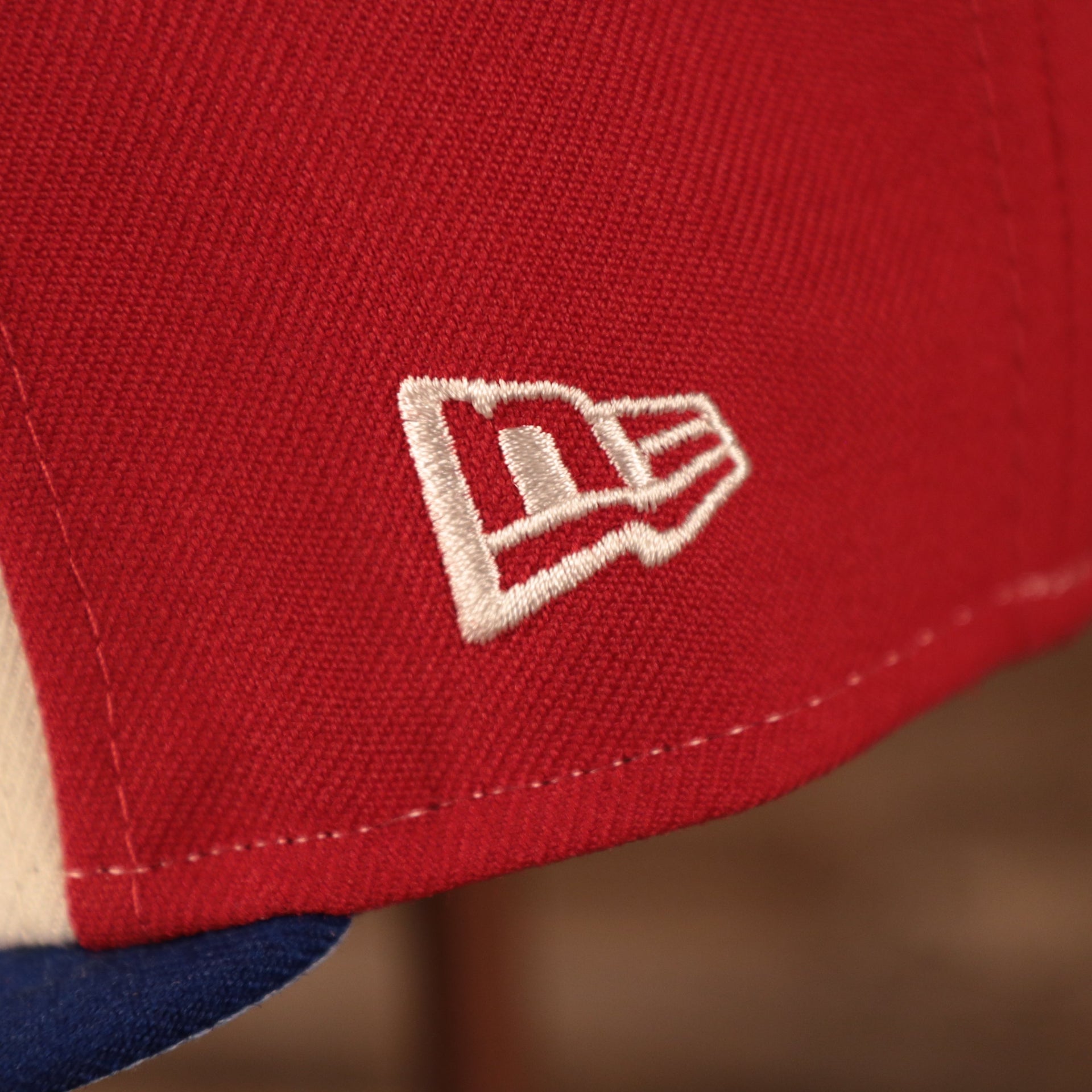 Close up of the New Era logo on the Montreal Expos 1982 All Star Game Partie D'etoiles Crystal Side Patch Icy Blue Bottom 59Fifty Fitted Cap