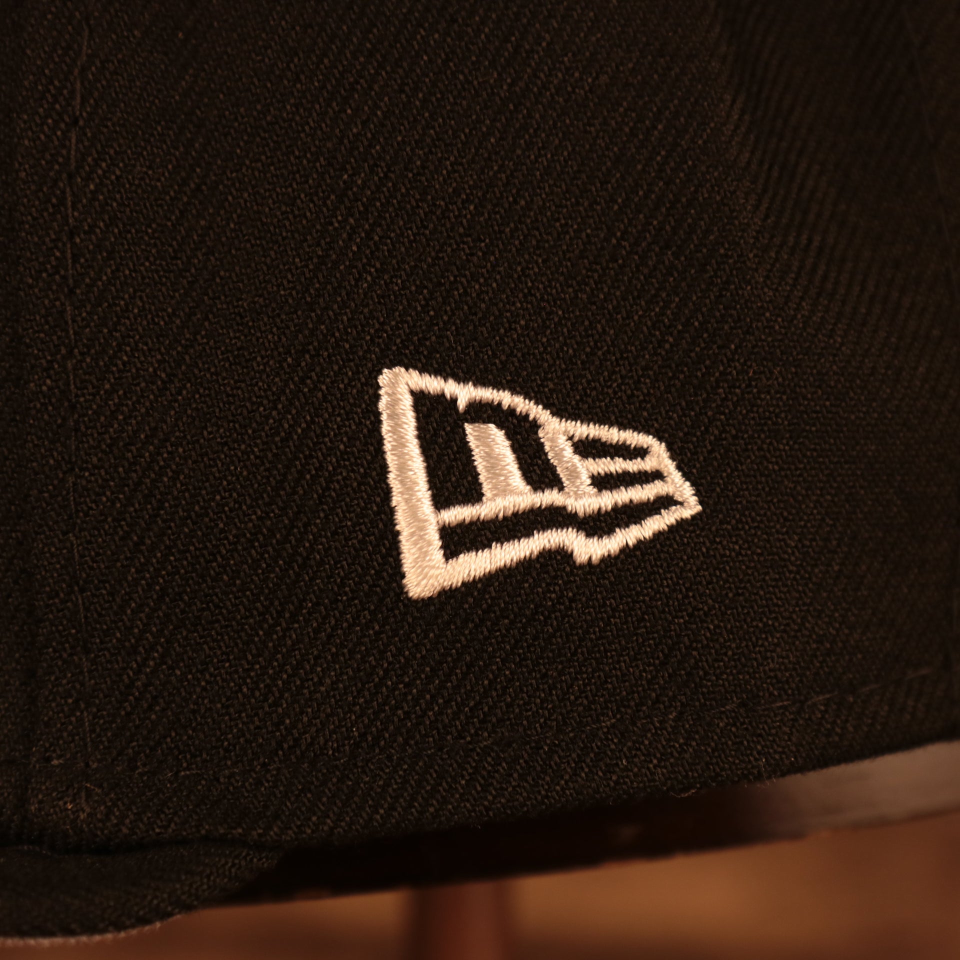 Close up of the New Era logo on the Brooklyn Nets "City Cluster" Side Patch Gray Bottom Black 59Fifty Fitted Cap