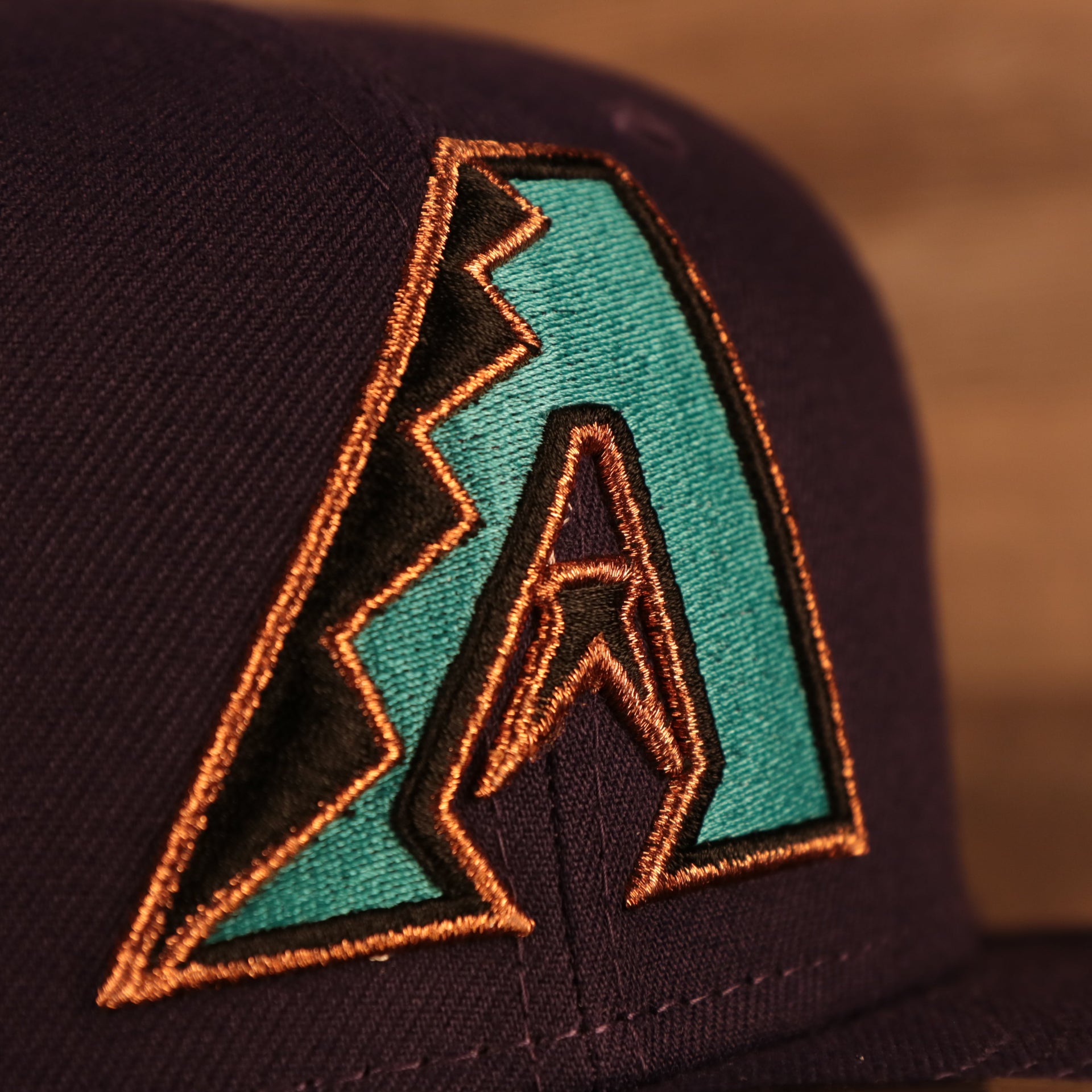 Close up of the front logo on the  Arizona Diamondbacks "City Cluster" Side Patch Gray Bottom Purple 59Fifty Fitted Cap