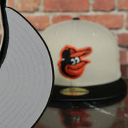 grey under visor on the Baltimore Orioles World Class 3-Time World Series Champions Two Tone Grey Bottom | Sand/Black 59Fifty Fitted Cap
