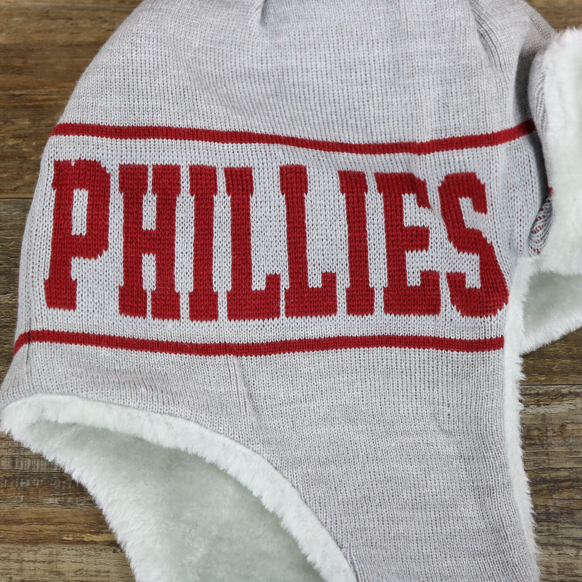 The Cooperstown Philadelphia Phillies Logo Wrapped Around Wordmark Trapper Hat | Gray Ushanka Hat laying down