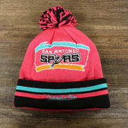 The backside of the San Antonio Spurs Retro Logo Two Sided Cuffed Winter Beanie | Pink And Black Winter Beanie