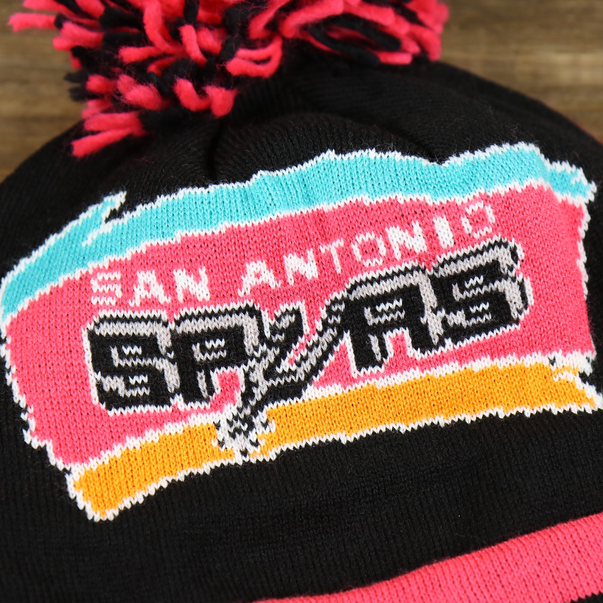 The San Antonio Spurs Retro Logo on the San Antonio Spurs Retro Logo Two Sided Cuffed Winter Beanie | Pink And Black Winter Beanie