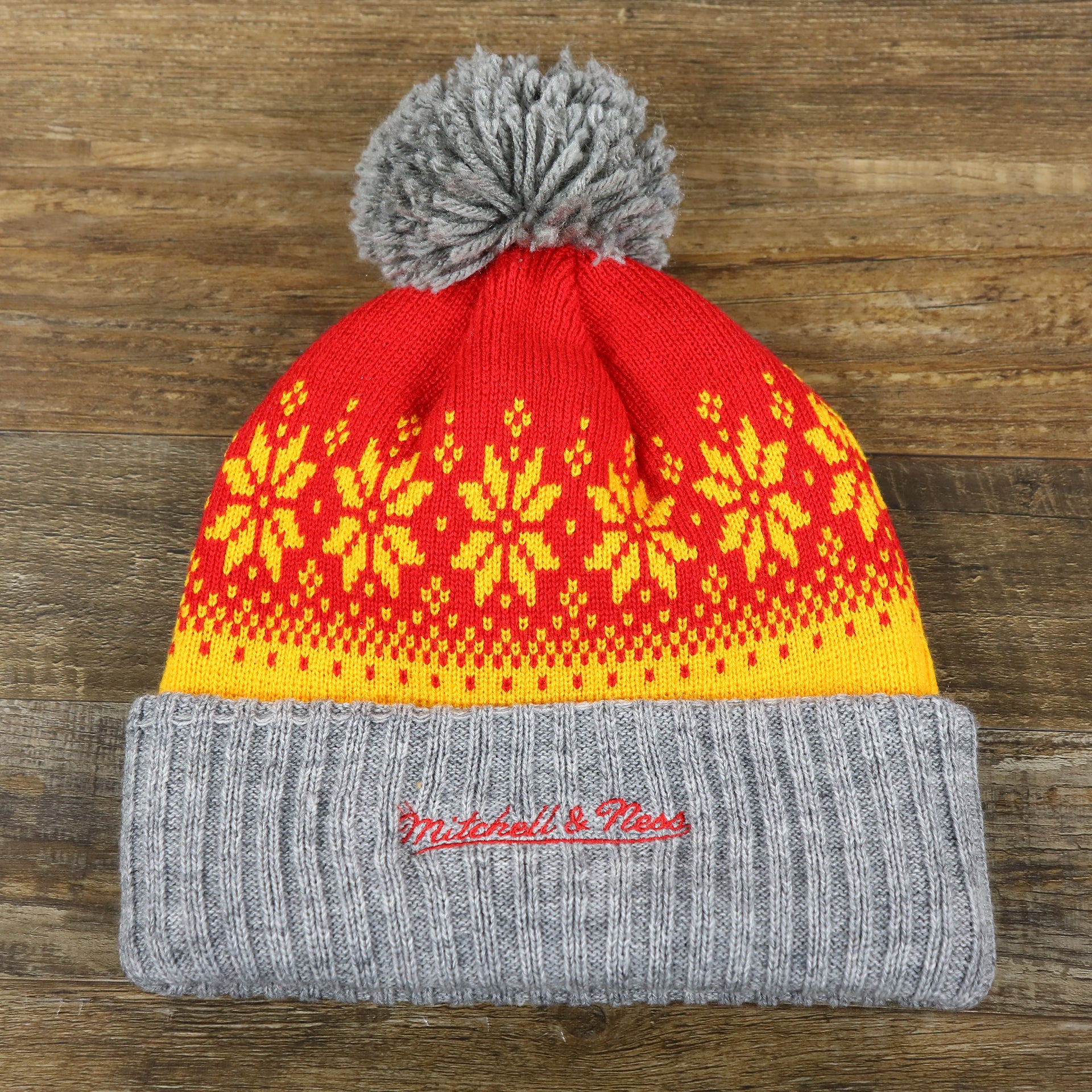 the backside of the Retro Houston Rockets Arctic Snowflake Ugly Sweater Pattern Cuffed Beanie With Pom Pom | Yellow, Maroon, and Gray Winter Beanie