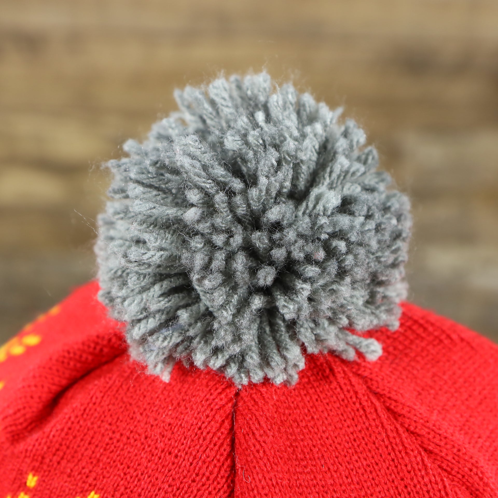 The Gray Pom Pom on the Retro Houston Rockets Arctic Snowflake Ugly Sweater Pattern Cuffed Beanie With Pom Pom | Yellow, Maroon, and Gray Winter Beanie