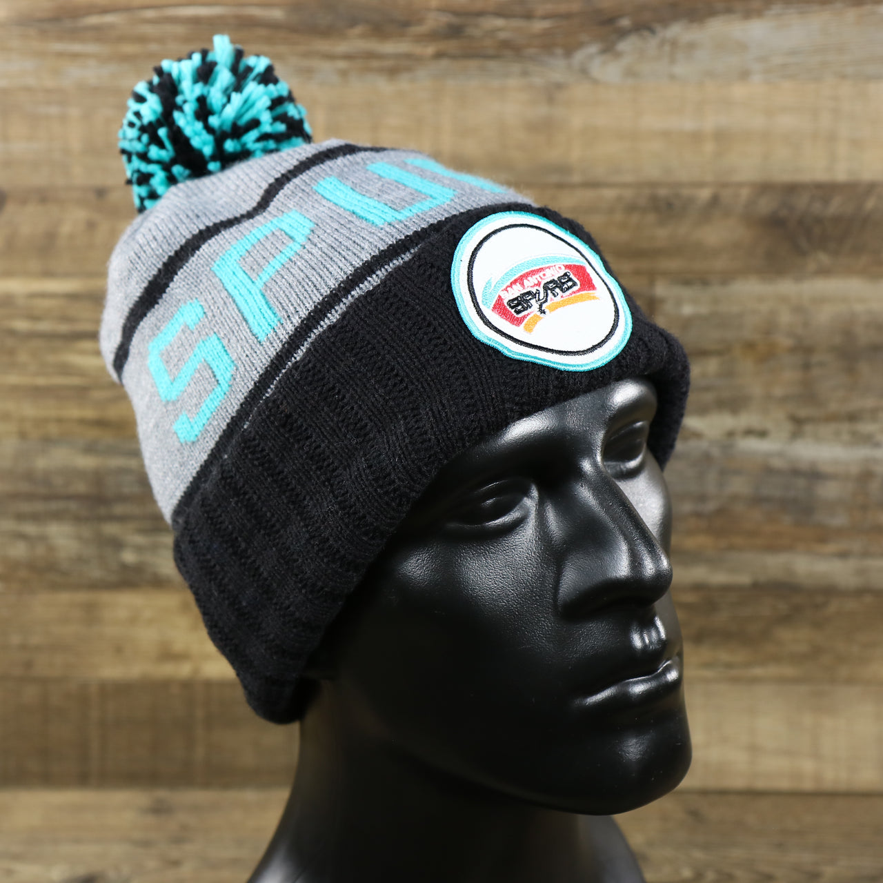 The Retro San Antonio Spurs Striped Wordmark Cuffed Pom Pom Beanie | Gray And Black Winter Beanie
