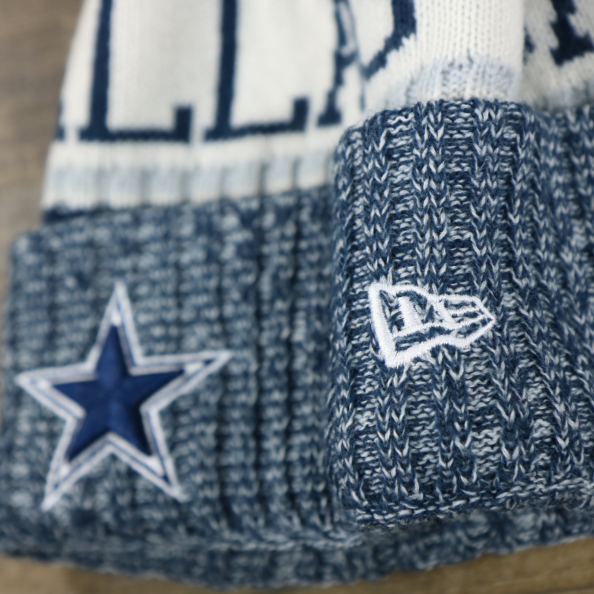 The New Era Logo on the Dallas Cowboys On Field Cuffed Fisherman Knit Beanie | Navy Blue Winter Beanie