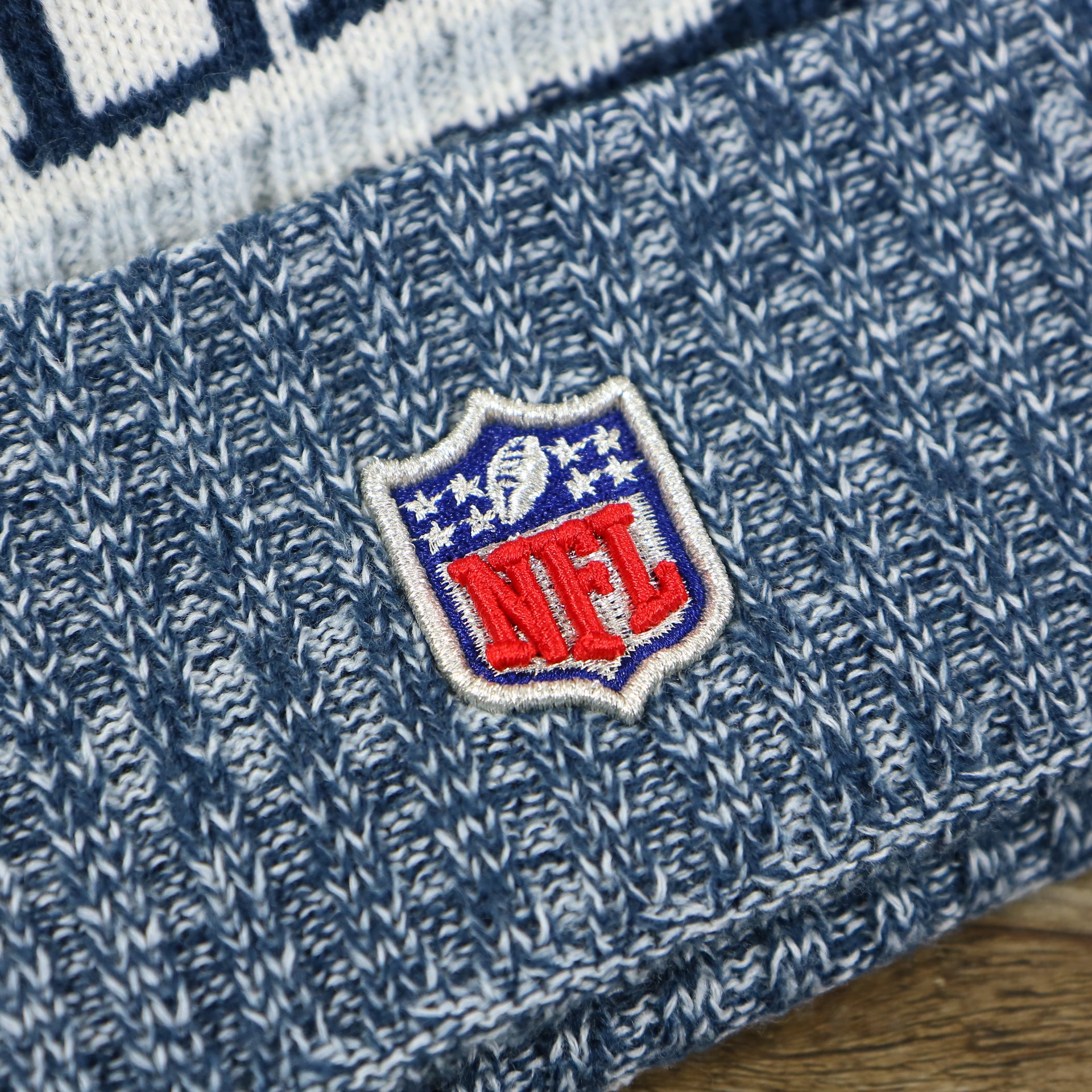 The NFL Logo on the Dallas Cowboys On Field Cuffed Fisherman Knit Beanie | Navy Blue Winter Beanie