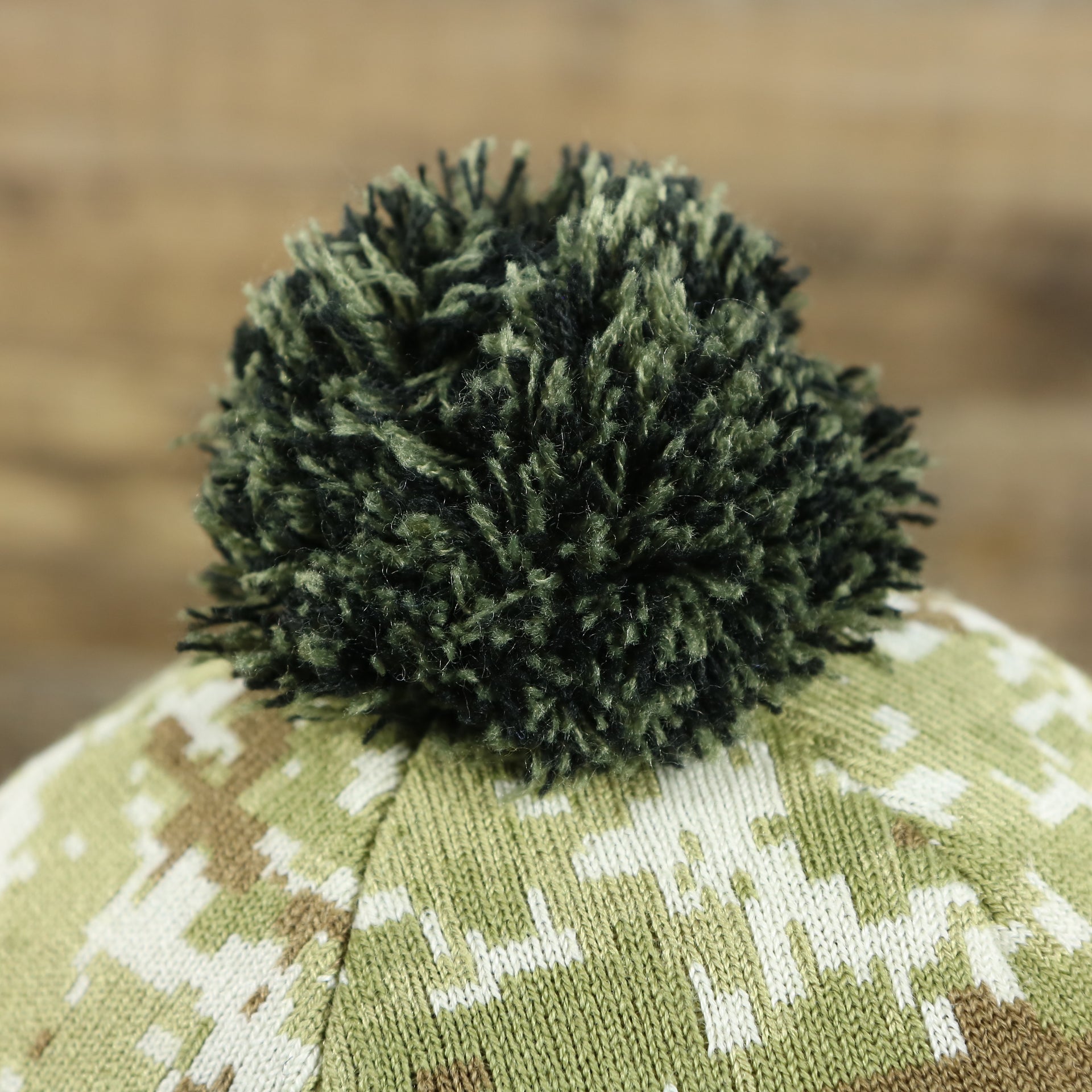 The Camo Pom Pom on the Pittsburgh Steelers NFL Salute To Service Cuffed Winter Beanie | Camo and Black Beanie