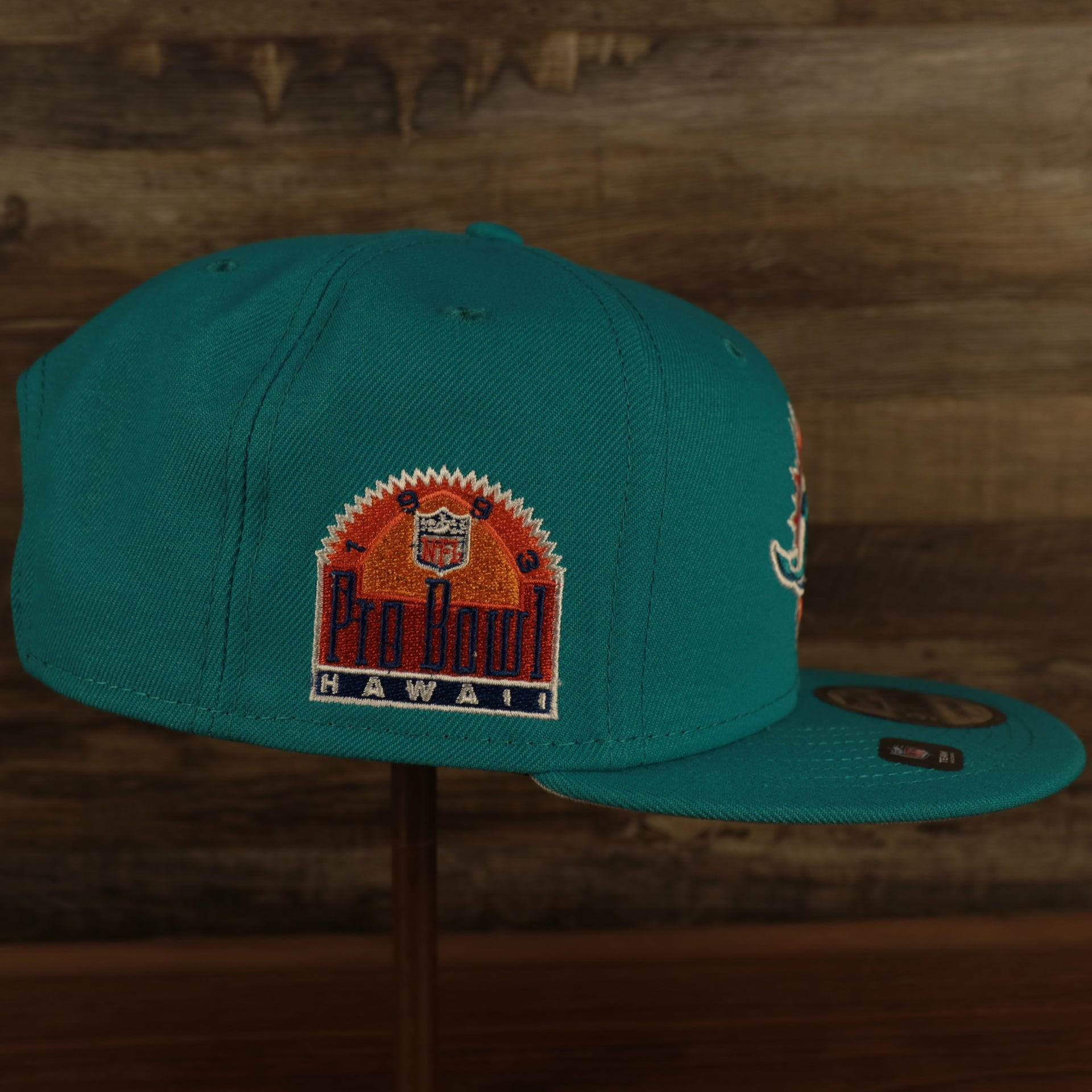 wearers right side on the Miami Dolphins "Patch Up" 1993 Pro Bowl Side Patch Gray Bottom 59Fifty Teal Fitted Cap
