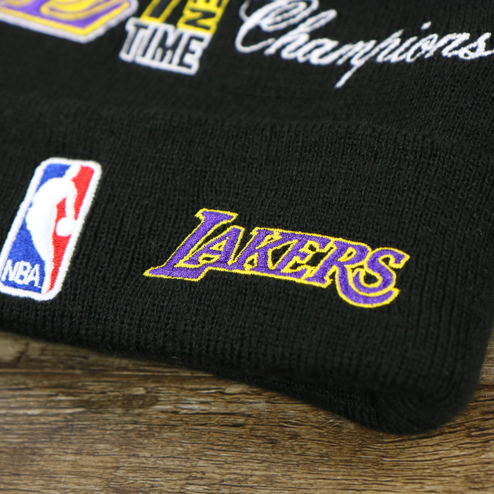 The lakers Wordmark on the Los Angeles Lakers All Over NBA Finals Side Patch 17x Champion Knit Cuff Beanie | New Era, Black