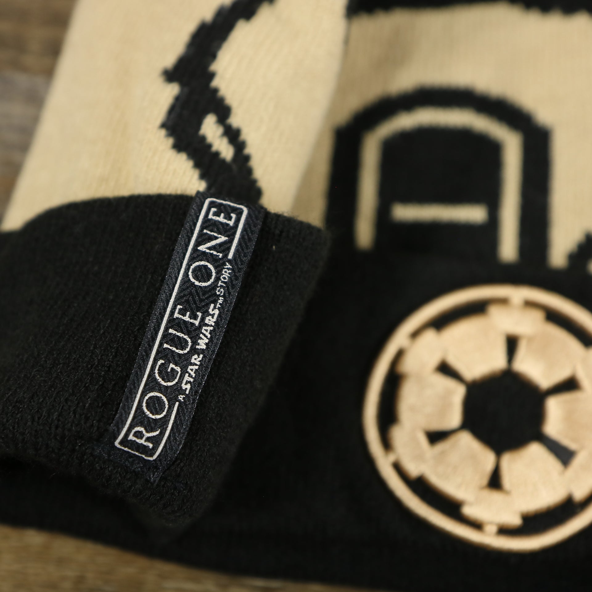 The Rouge One Tag on the Star War Sandtrooper Cuffed Beanie With Black Pom Pom | Tan And Black Beanie