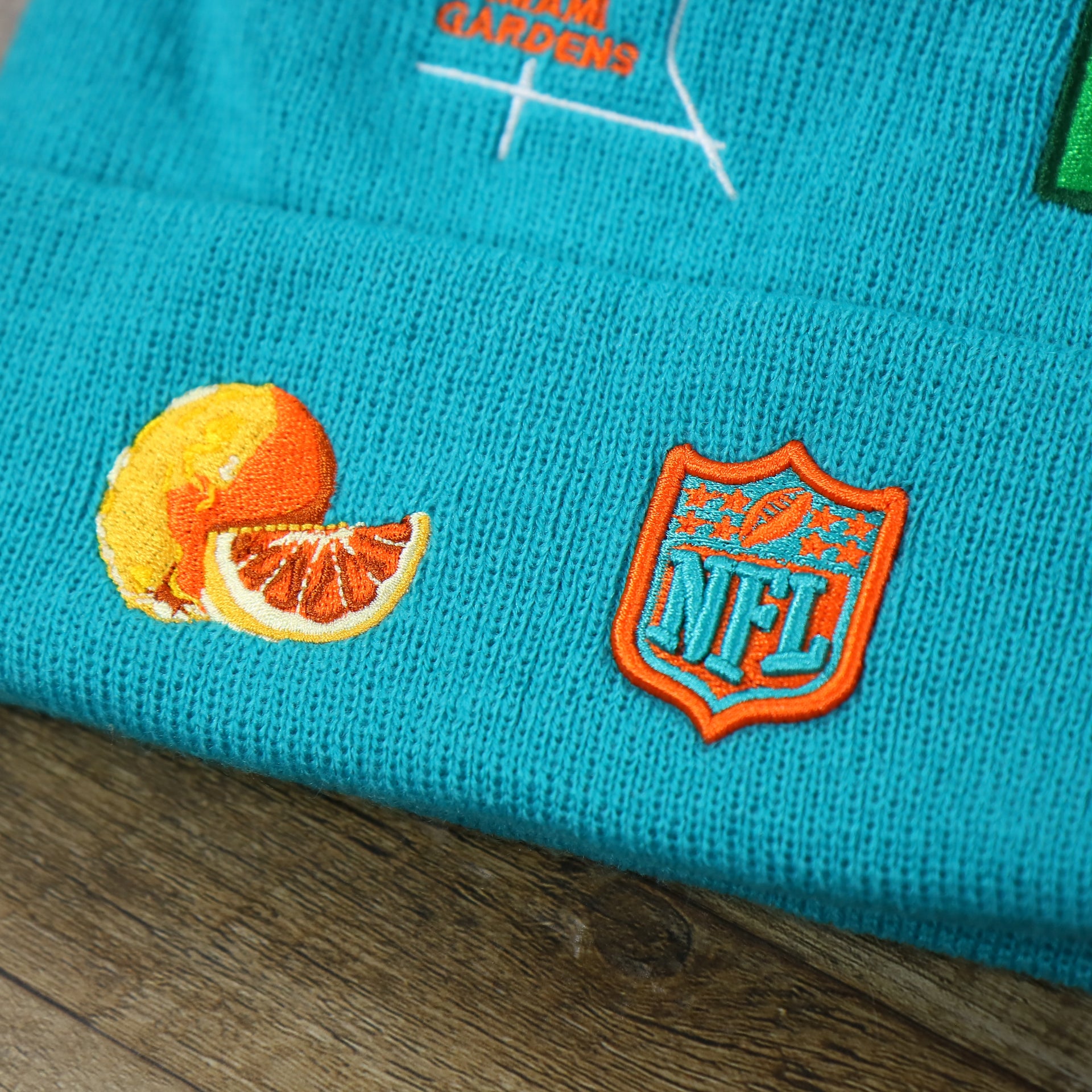 The Orange Patch and NFL Logo on the Miami Dolphins "City Transit" 59Fifty Fitted Matching All Over Side Patch Beanie