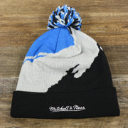 The backside of the Orlando Magics Paint Brush Cuffed Winter Beanie With Pom Pom | Black, Gray, And Blue Winter Beanie