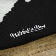 The Mitchell And Ness Script Logo on the Orlando Magics Paint Brush Cuffed Winter Beanie With Pom Pom | Black, Gray, And Blue Winter Beanie