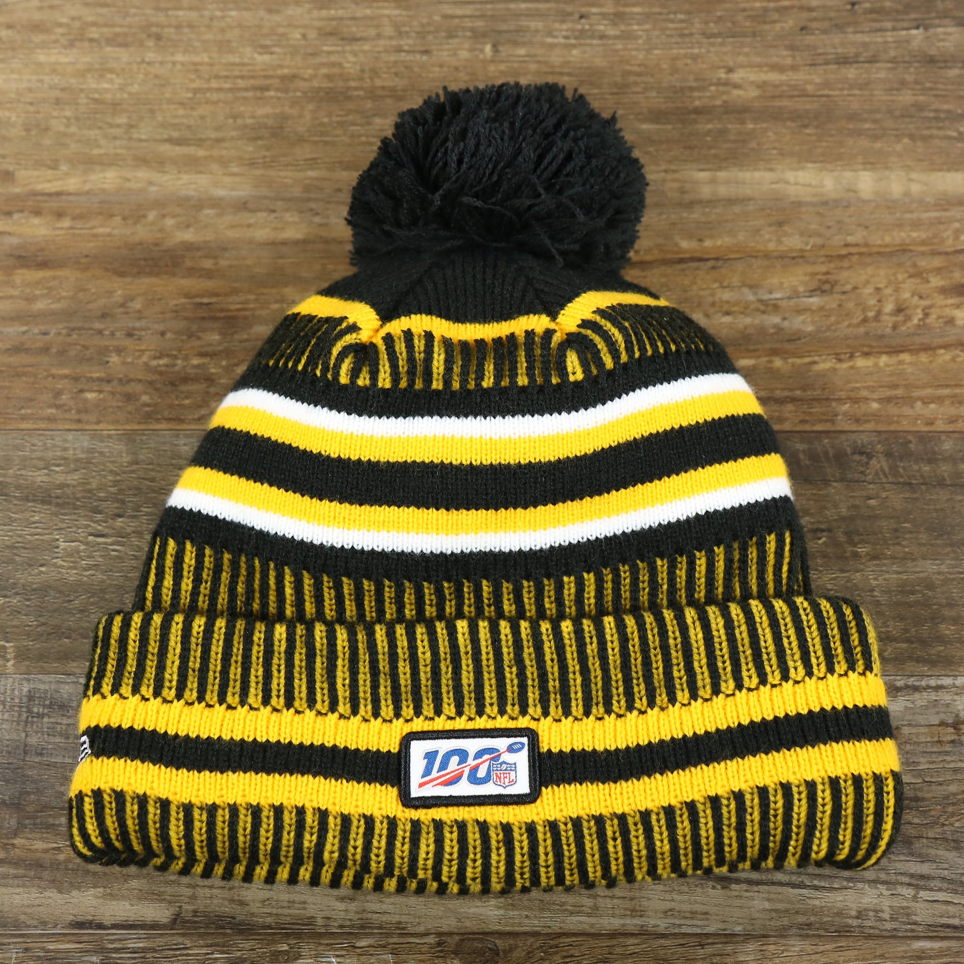 The backside of the Pittsburgh Steelers On Field Sideline Cuffed Winter Knit Pom Pom Beanie | Yellow Winter Beanie
