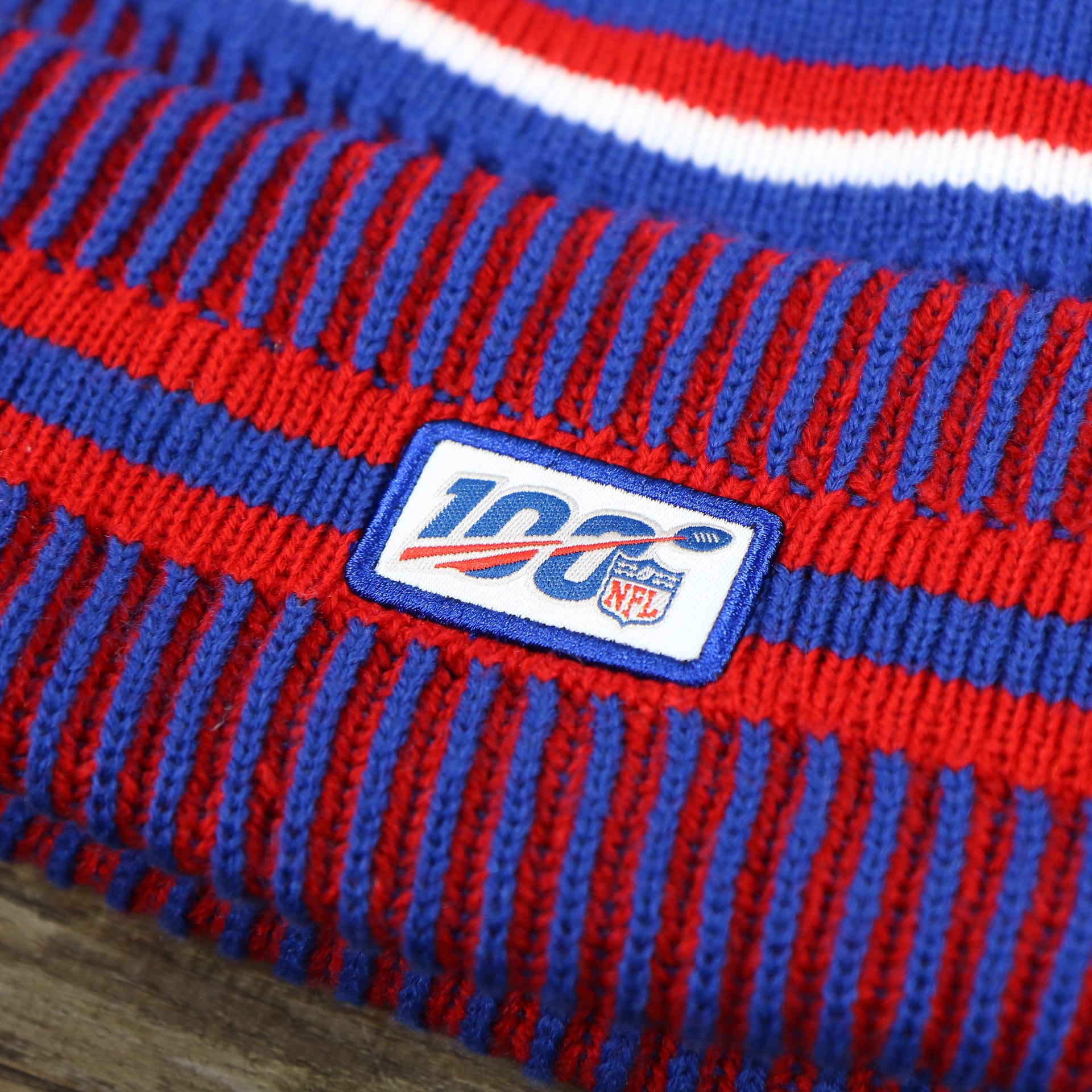 The NFL 100 Logo on the New York Giants On Field Sideline Cuffed Winter Knit Pom Pom Beanie | Red Winter Beanie