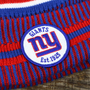 The New York Giants Sideline Patch on the New York Giants On Field Sideline Cuffed Winter Knit Pom Pom Beanie | Red Winter Beanie