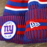 The New Era Logo on the New York Giants On Field Sideline Cuffed Winter Knit Pom Pom Beanie | Red Winter Beanie