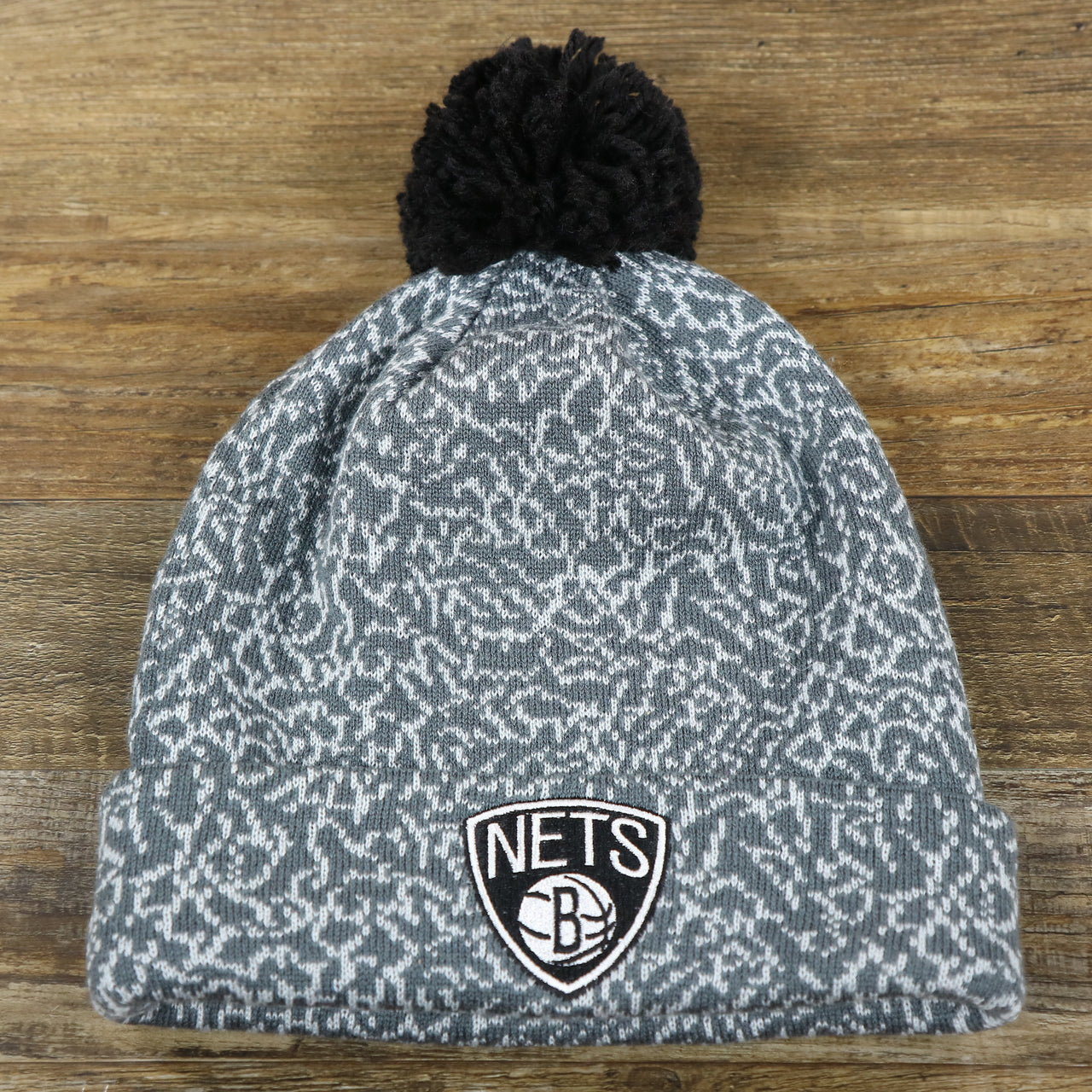 The front of the Brooklyn Nets Jordan 3 Matching Concrete Print Winter Beanie With Pom Pom | Gray Winter Beanie