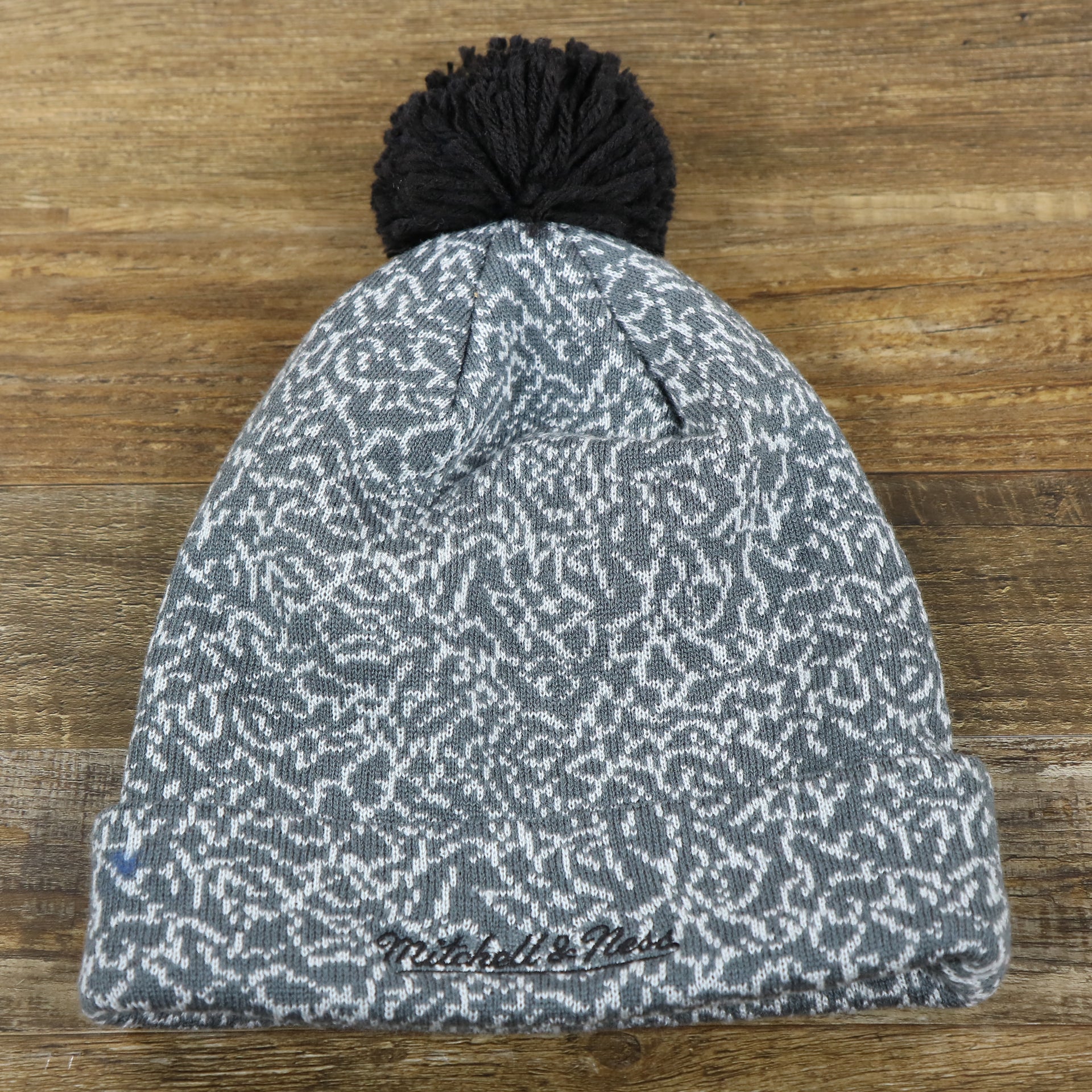 The backside of the Brooklyn Nets Jordan 3 Matching Concrete Print Winter Beanie With Pom Pom | Gray Winter Beanie
