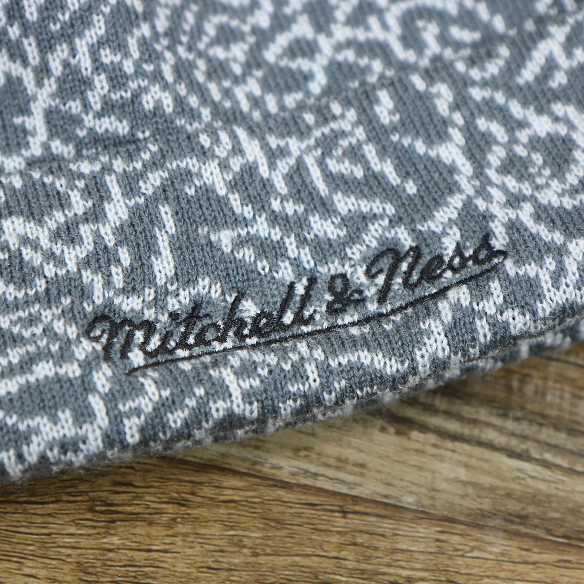 The Mitchell And Ness Script Logo on the Brooklyn Nets Jordan 3 Matching Concrete Print Winter Beanie With Pom Pom | Gray Winter Beanie