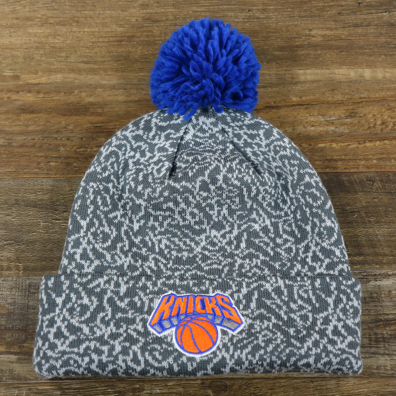 The front of the New York Knicks Jordan 3 Matching Concrete Print Winter Beanie With Pom Pom | Gray Winter Beanie