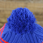 The Blue Pom Pom on the Philadelphia 76ers Knit Wordmark Phila Arch Lettering Join Or Die Snake NBA Draft Striped Beanie | Royal Blue and Red Beanie