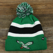 The front of the Legacy Philadelphia Eagles Cuffed Logo Striped Winter Beanie With Pom Pom | Kelly Green Winter Beanie
