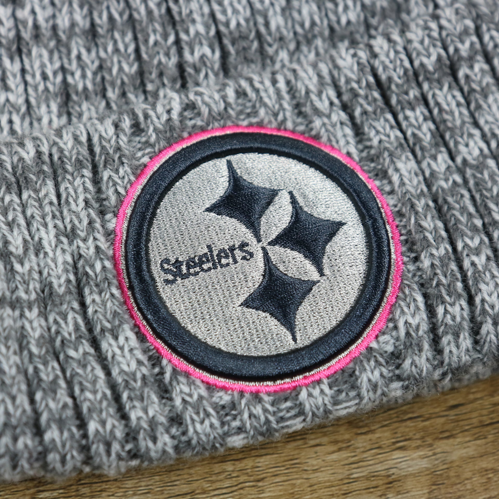 The Steelers Logo on the Pittsburgh Steelers On Field Crucial Catch Winter Knit Graphite Beanie | Gray Winter Beanie