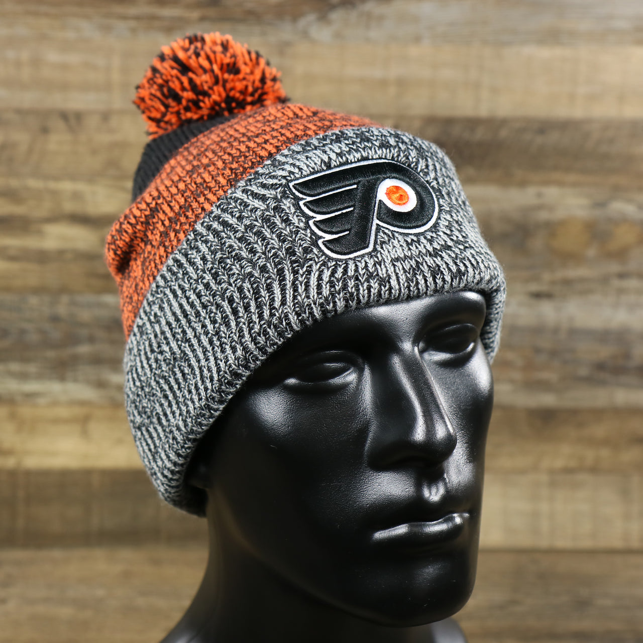 The Philadelphia Flyers Static Knit Cuffed Winter Beanie With Pom Pom | Black, Orange, And Gray Beanie