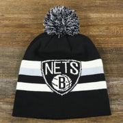 The front of the Brooklyn Nets Cuffless Striped Winter Beanie With Pom Pom | Black, White, And Gray Beanie