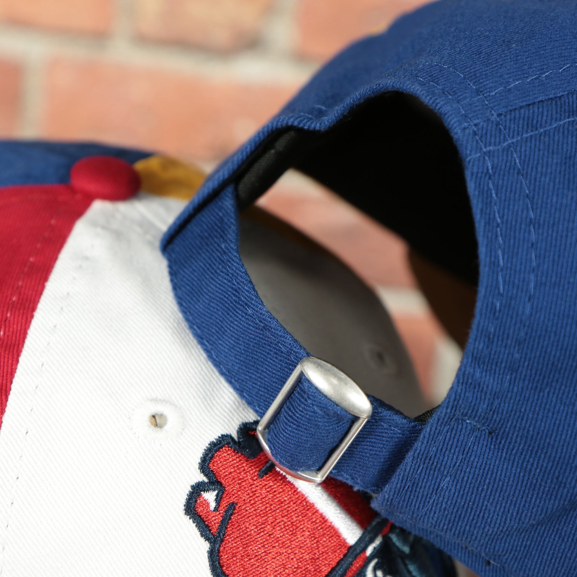 adjustable strap on the Jersey Shore Blueclaws Bucket Blueclaw MiLB Tan bottom 4 Tone | White/Red/Tan/Royal 9Twenty Child Dad Hat