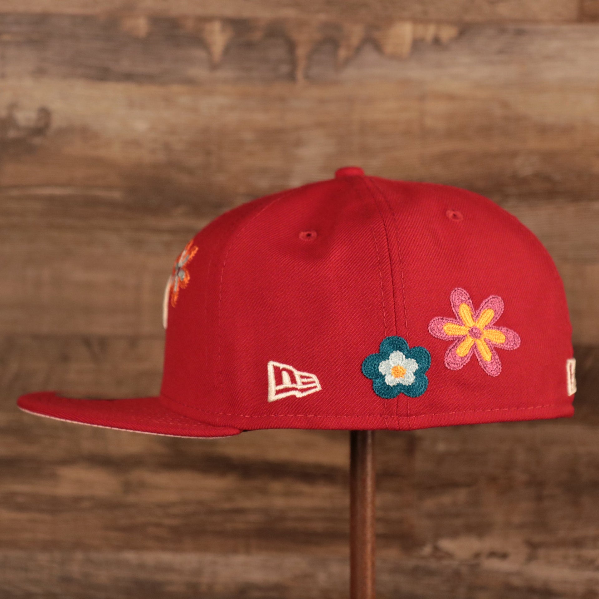 Wearer's left of the Philadelphia Phillies All Over Floral Pattern Flower Crotchet Side Patch Pink Bottom 59Fifty Fitted Cap
